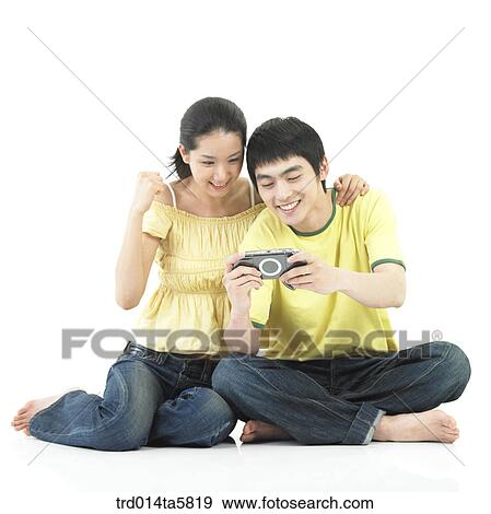 a couple with a PDA View Large Photo Image Stock Photo - a couple with a PDA. Fotosearch