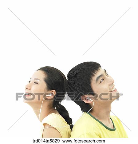 a smiling couple listening to music View Large Photo Image Stock Photo - a smiling couple listening to music. Fotosearch