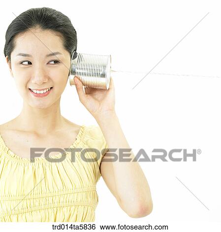 a smiling woman playing with a can View Large Photo Image Stock Photograph - a smiling woman playing with a can. Fotosearch