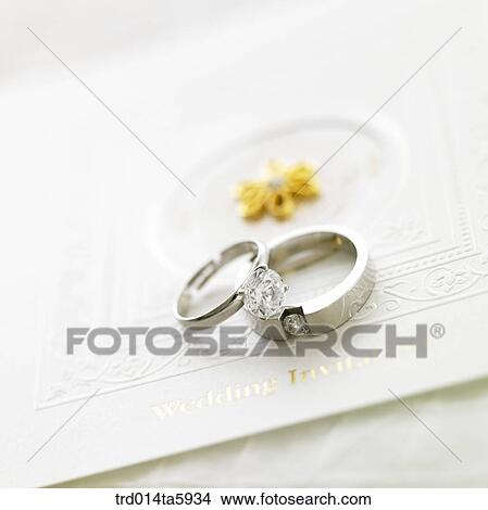 a bouquet, an invitation and a wedding ring on the table View Large Photo Image Picture - a bouquet, an invitation and a wedding ring on the table. Fotosearch