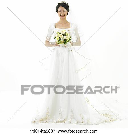Stock Photo - a bride holding a bouquet. Fotosearch