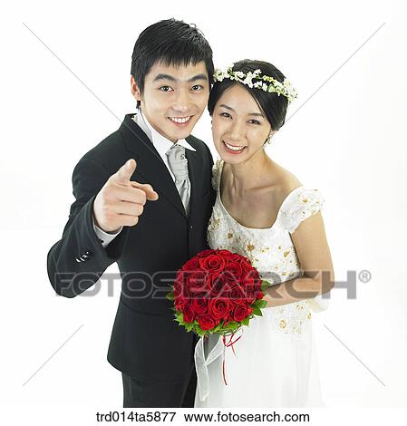 a bridegroom and a bride holding a bouquet View Large Photo Image Stock Photo - a bridegroom and a bride holding a bouquet. Fotosearch