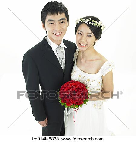 a bridegroom and a bride holding a bouquet View Large Photo Image Stock Photo - a bridegroom and a bride holding a bouquet. Fotosearch