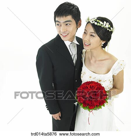 a bridegroom and a bride holding a bouquet View Large Photo Image Stock Photograph - a bridegroom and a bride holding a bouquet. Fotosearch