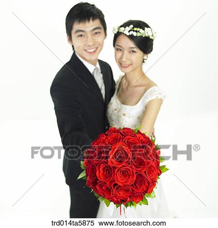 a bridegroom and a bride holding a bouquet View Large Photo Image Stock Photography - a bridegroom and a bride holding a bouquet. Fotosearch