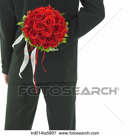 a bridegroom holding a bouquet backward View Large Photo Image Stock Photo - a bridegroom holding a bouquet backward. Fotosearch