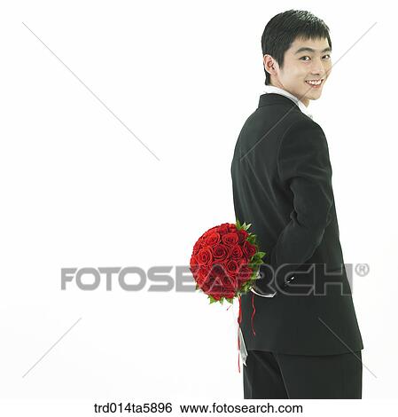 a bridegroom holding a bouquet backward View Large Photo Image Stock Photograph - a bridegroom holding a bouquet backward. Fotosearch