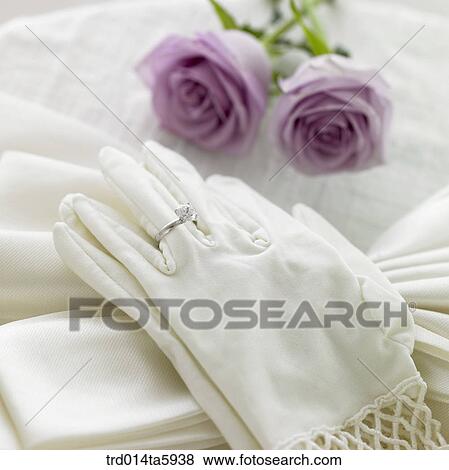 a bride's gloves and a wedding ring on the table View Large Photo Image Stock Photo - a bride's gloves and a wedding ring on the table. Fotosearch