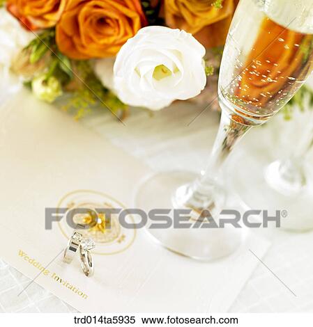 an invitation, a wedding ring and champagne on the table View Large Photo Image Stock Photography - an invitation, a wedding ring and champagne on the table. Fotosearch