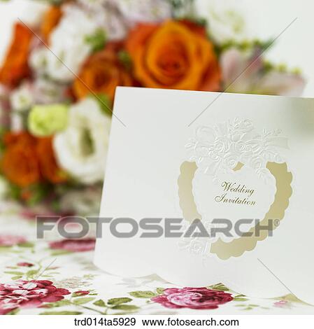 an invitation and a bouquet on the table View Large Photo Image Stock Photo - an invitation and a bouquet on the table. Fotosearch