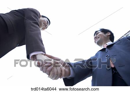 a businessman and a businesswoman shaking their hands View Large Photo Image Picture - a businessman and a businesswoman shaking their hands. Fotosearch