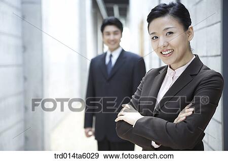 a businessman and a smiling businesswoman View Large Photo Image Stock Photo - a businessman and a smiling businesswoman . Fotosearch