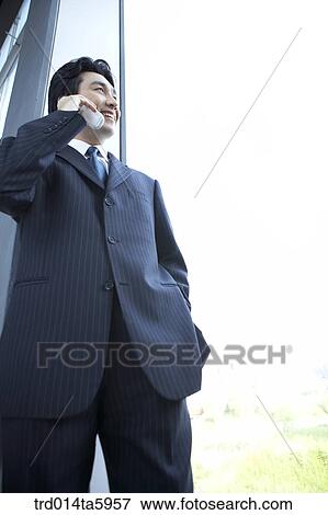 a businessman calling with a mobile phone View Large Photo Image Stock Photo - a businessman calling with a mobile phone. Fotosearch