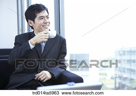 a businessman drinking a cup of coffee View Large Photo Image Stock Image - a businessman drinking a cup of coffee. Fotosearch
