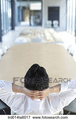 Stock Photo - a businessman in a conference room. Fotosearch