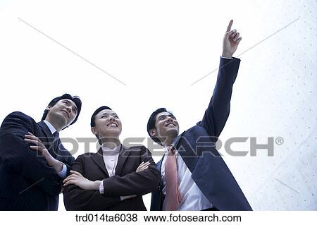 a businessman pointing at something and his colleagues View Large Photo Image Stock Photo - a businessman pointing at something and his colleagues. Fotosearch