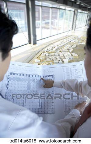 a businessman pointing at something with his finger View Large Photo Image Stock Photography - a businessman pointing at something with his finger . Fotosearch
