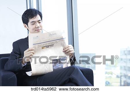 a businessman reading a newspaper View Large Photo Image Stock Image - a businessman reading a newspaper. Fotosearch