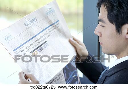 a businessman reading a newspaper View Large Photo Image Stock Photography - a businessman reading a newspaper. Fotosearch