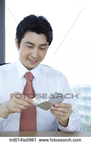 Stock Image - a businessman receiving his namecard. Fotosearch