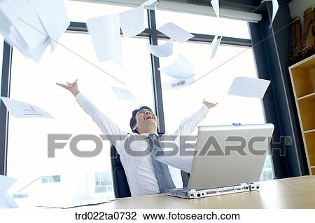 Stock Image - a businessman throwing up a document. Fotosearch