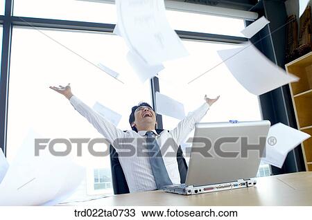 a businessman throwing up a document View Large Photo Image Stock Image - a businessman throwing up a document. Fotosearch