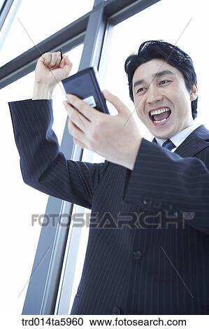 Stock Image - a businessman with a PDA. Fotosearch