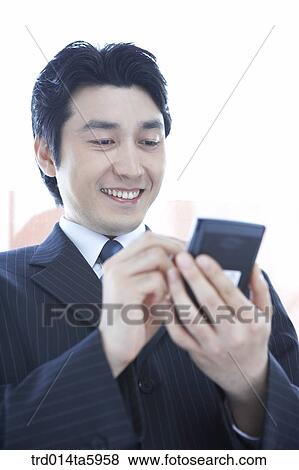 a businessman with a PDA View Large Photo Image Stock Photo - a businessman with a PDA. Fotosearch