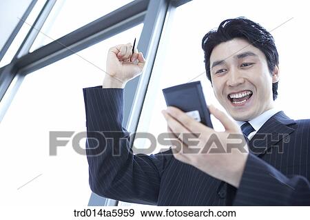 a businessman with a PDA View Large Photo Image Stock Photo - a businessman with a PDA. Fotosearch