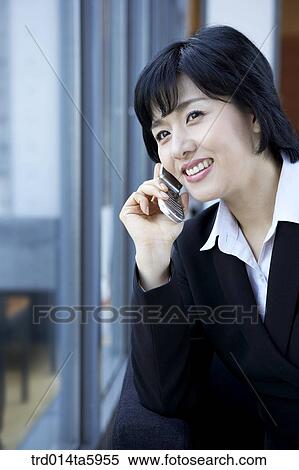 a businesswoman calling with a mobile phone View Large Photo Image Stock Photography - a businesswoman calling with a mobile phone. Fotosearch