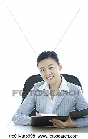 a businesswoman holding a clipboard View Large Photo Image Stock Photo - a businesswoman holding a clipboard. Fotosearch