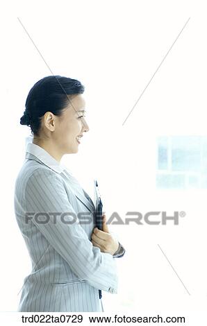 a businesswoman holding a clipboard View Large Photo Image Stock Photo - a businesswoman holding a clipboard. Fotosearch