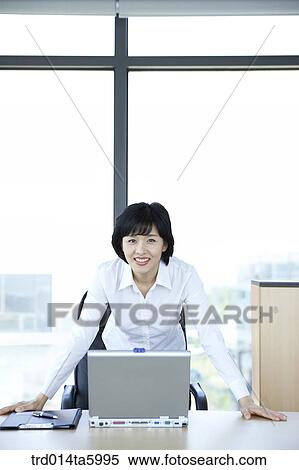 a businesswoman in front of a notebook View Large Photo Image Stock Photography - a businesswoman in front of a notebook. Fotosearch