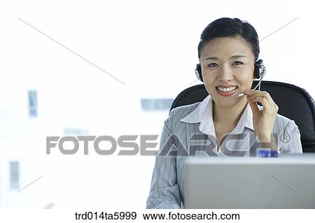 a businesswoman wearing a headset View Large Photo Image Stock Photo - a businesswoman wearing a headset. Fotosearch