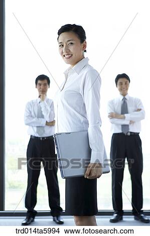 Picture - a businesswoman with a notebook and a businessman. Fotosearch