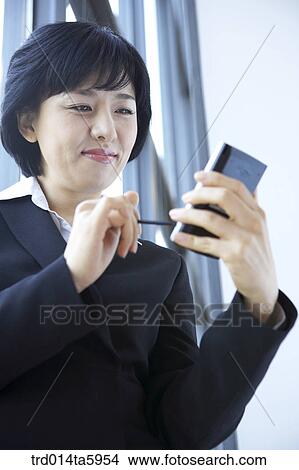 a businesswoman with a PDA View Large Photo Image Picture - a businesswoman with a PDA. Fotosearch