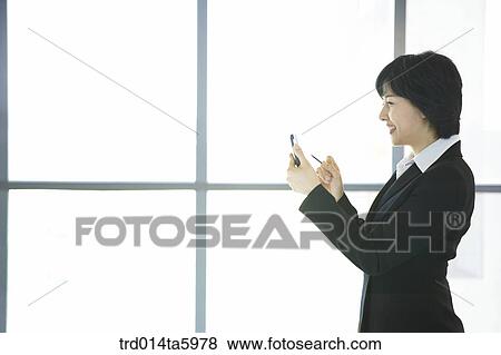 a businesswoman with a PDA View Large Photo Image Stock Photo - a businesswoman with a PDA. Fotosearch
