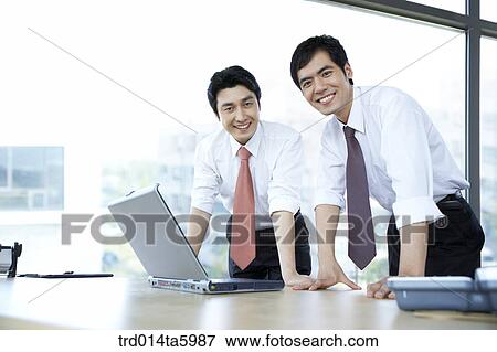 a smiling businessman and a notebook View Large Photo Image Stock Photo - a smiling businessman and a notebook. Fotosearch