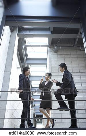 a talking businessman and a businesswoman View Large Photo Image Stock Image - a talking businessman and a businesswoman . Fotosearch