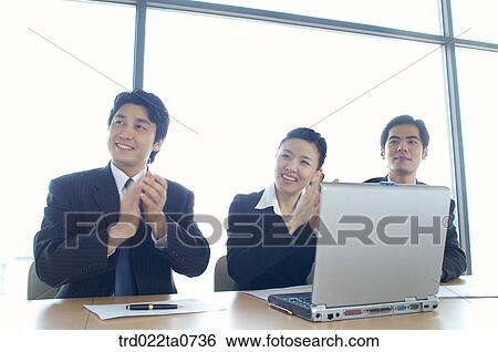 an applausing businessman and a businesswoman View Large Photo Image Stock Photograph - an applausing businessman and a businesswoman . Fotosearch