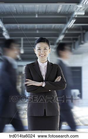 two businessmen and a smiling businesswoman View Large Photo Image Picture - two businessmen and a smiling businesswoman . Fotosearch