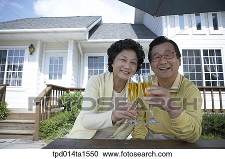 Stock Image - family, cheers, day, daytime, old couple, old. Fotosearch
