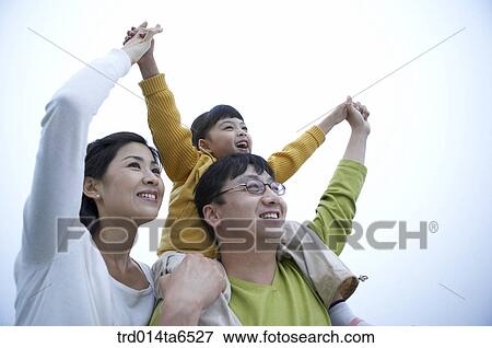 Stock Photo - family, day, daytime, Asian, low angle, rocking horse. Fotosearch