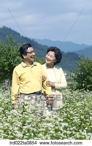 Picture - family, flower garden, day, daytime, old couple, old. Fotosearch