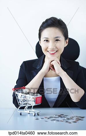 Stock Image - coin, person, shopping cart, inside, sitting, woman, smile. Fotosearch