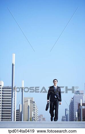 Stock Photo - day, daytime, Asian, low angle, business, businessman. Fotosearch