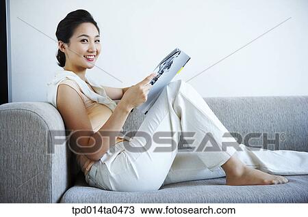 Stock Image - reading, Asian, person, inside, leisure, woman, smile. Fotosearch