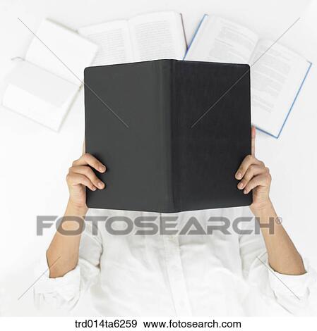 Stock Photo - lying, reading, person, office supply, book, supply, focus. Fotosearch