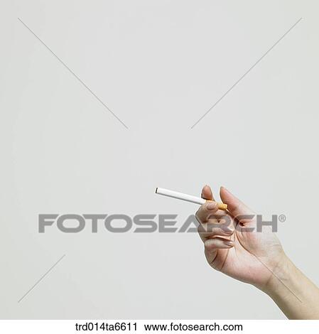 Stock Image - person, body, hand, closeup, object, cigarette. Fotosearch