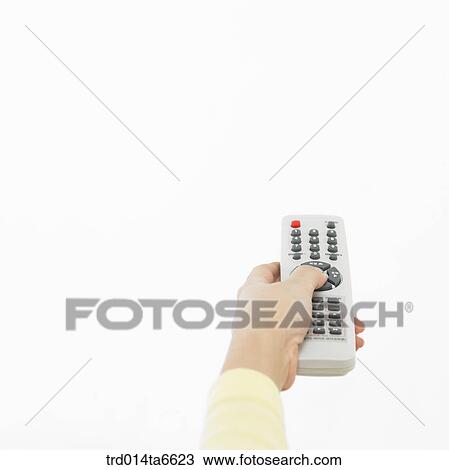 Stock Image - person, body, hand, closeup, object, remote control. Fotosearch